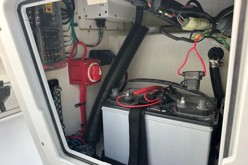 Slide: The Image of 2021 Beavertail Skiffs Vengeance battery compartment with wiring and fuse box. - 17