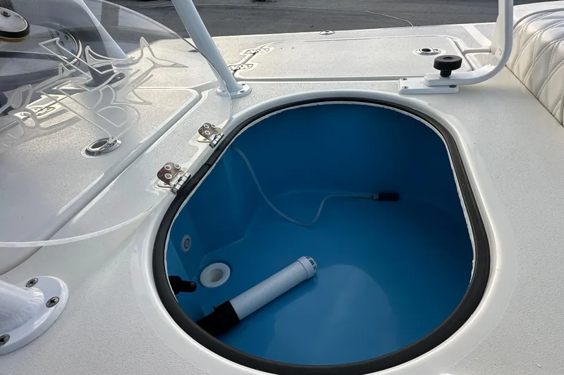 Slide: The Image of 2021 Beavertail Skiffs Vengeance boat livewell with blue interior and white deck. - 19