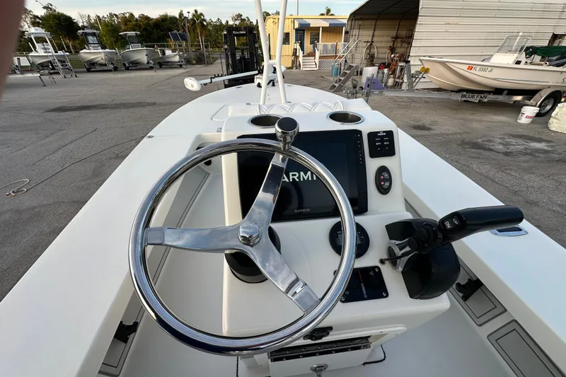 Slide: The Image of 2021 Beavertail Skiffs Vengeance boat dashboard with steering wheel and Garmin display. - 7