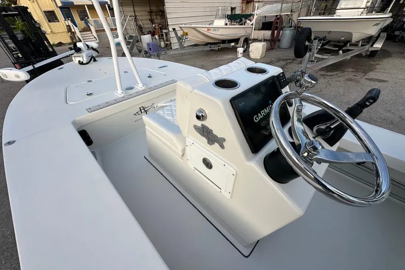 Slide: The Image of 2021 Beavertail Skiffs Vengeance boat interior with steering wheel and Garmin display. - 8