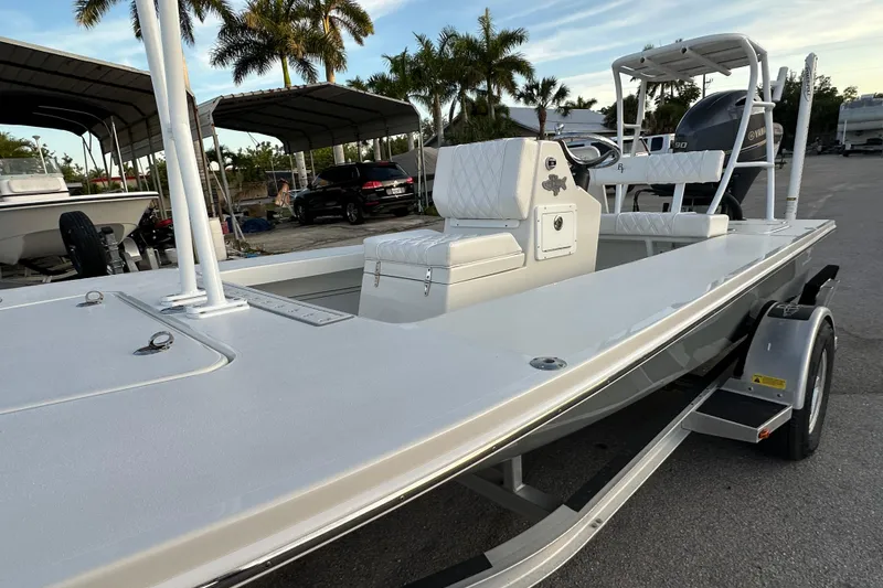 Slide: The Image of 2021 Beavertail Skiffs Vengeance boat on trailer, parked near palm trees. - 9