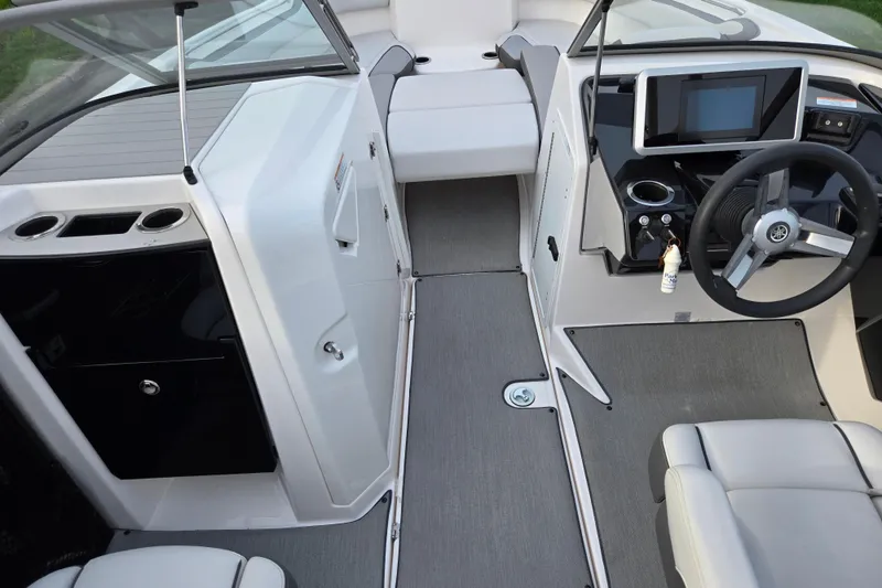 Slide: The Image of 2021 Yamaha Boats AR250 interior with steering wheel, dashboard, and seating area. - 11