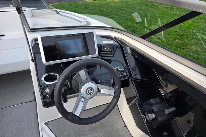 Slide: The Image of 2021 Yamaha Boats AR250 helm with steering wheel and touchscreen display. - 12