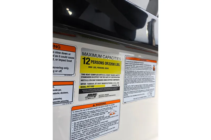 Slide: The Image of 2021 Yamaha Boats AR250 capacity label, maximum 12 persons or 2200 lbs, safety warnings included. - 13