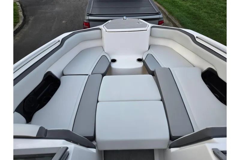 Slide: The Image of 2021 Yamaha Boats AR250 interior with cushioned seating and cup holders. - 16