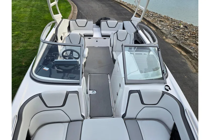 Slide: The Image of 2021 Yamaha Boats AR250 interior with sleek seating and modern dashboard design. - 19