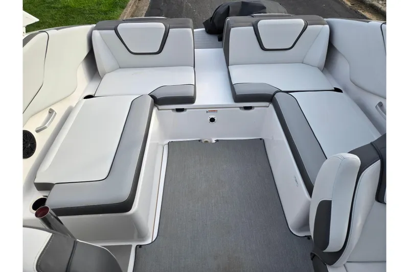 Slide: The Image of 2021 Yamaha Boats AR250 interior seating with gray and white upholstery. - 21