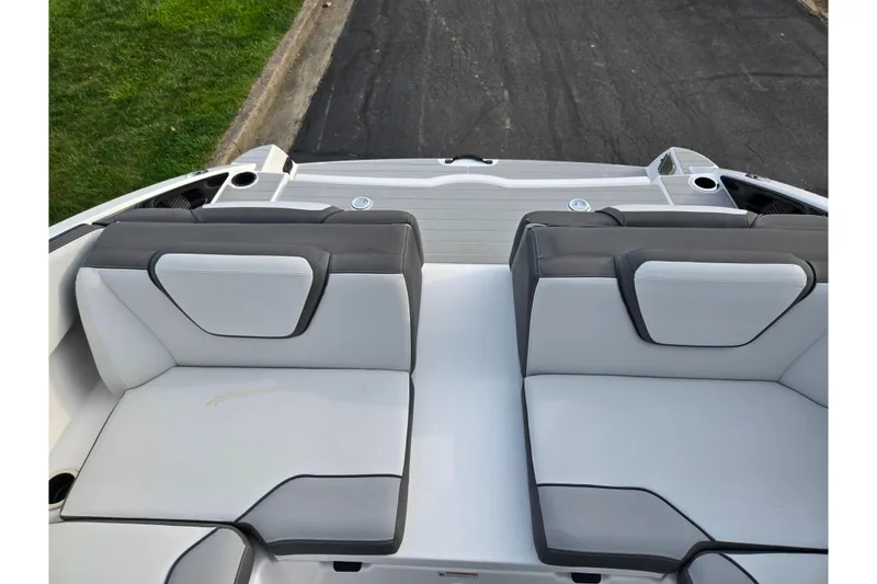 Slide: The Image of 2021 Yamaha Boats AR250 interior seating with sleek gray and white upholstery. - 22
