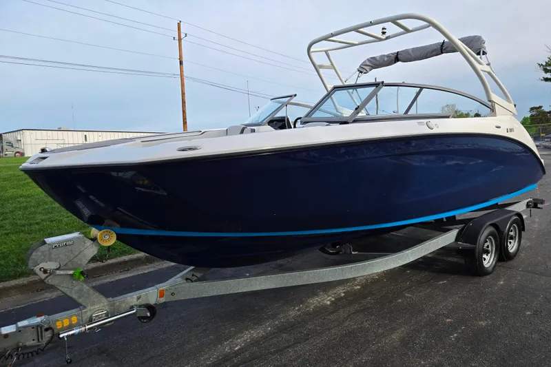 Slide: The Image of 2021 Yamaha Boats AR250 on trailer, sleek design, blue hull, ready for adventure. - 5
