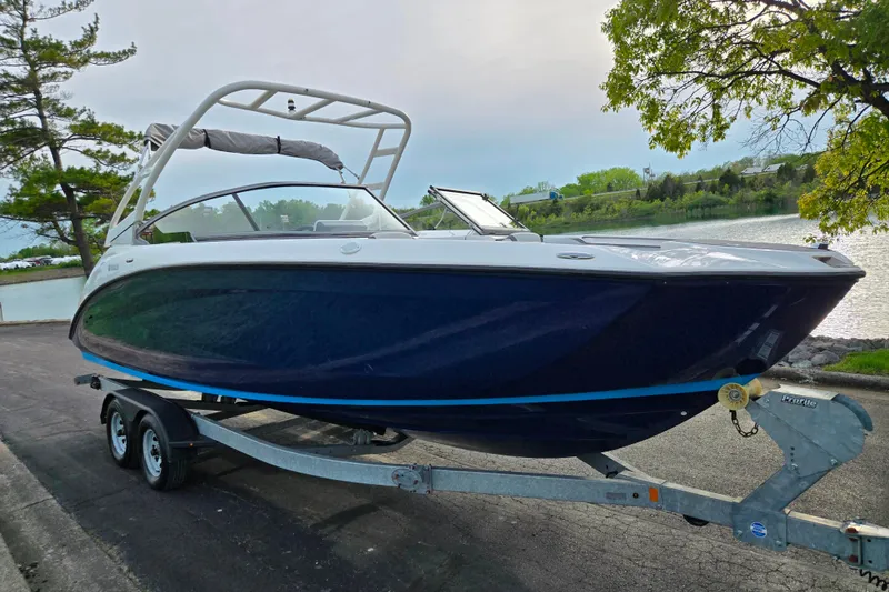 Slide: The Image of 2021 Yamaha Boats AR250 on trailer by a scenic lakeside. - 8