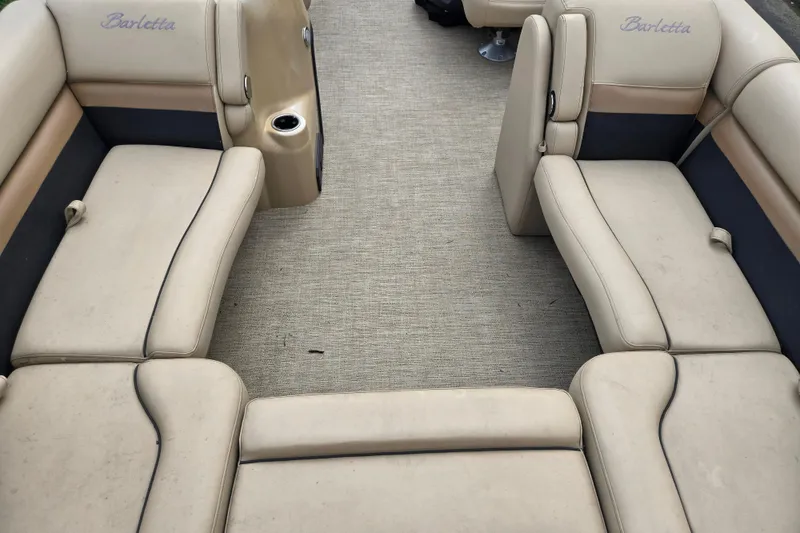Slide: The Image of 2021 Barletta C22QC boat interior with beige seating and carpeted floor. - 11