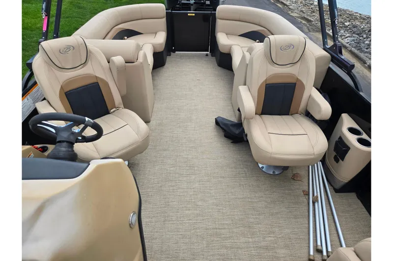 Slide: The Image of 2021 Barletta C22QC boat interior with beige seating and steering wheel. - 12