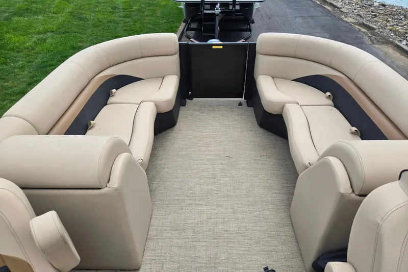 Slide: The Image of 2021 Barletta C22QC pontoon boat interior with beige seating and carpeted floor. - 14