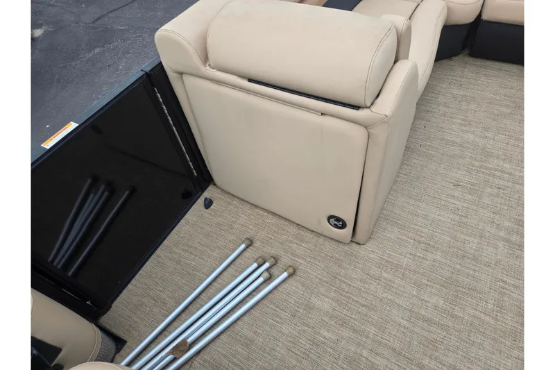 Slide: The Image of 2021 Barletta C22QC boat interior with beige seating and metal poles on carpeted floor. - 21