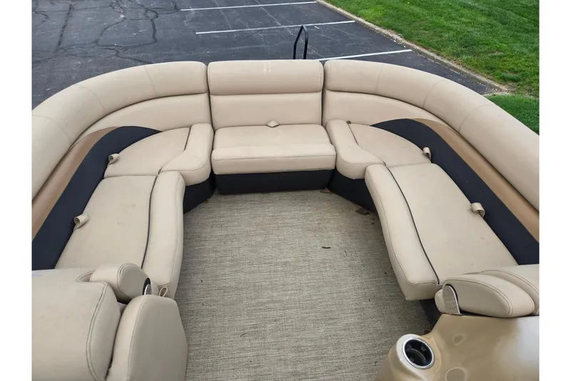 Slide: The Image of 2021 Barletta C22QC pontoon boat interior with beige seating and cup holder. - 22