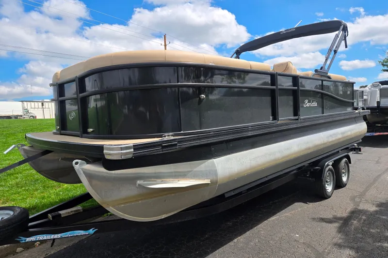 Slide: The Image of 2021 Barletta C22QC pontoon boat on trailer under blue sky. - 5