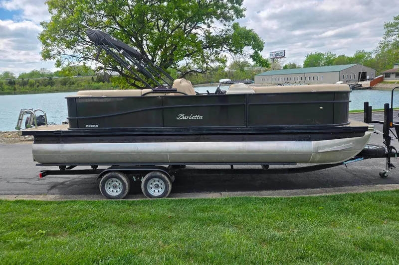 Slide: The Image of 2021 Barletta C22QC pontoon boat on trailer by a lake. - 9