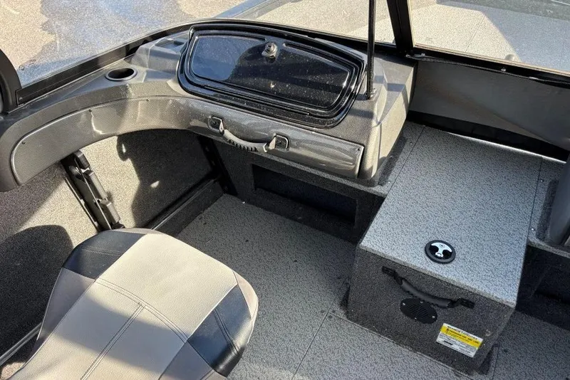Slide: The Image of 2024 Crestliner 1650 Fish Hawk WT interior with seating and storage compartments. - 6