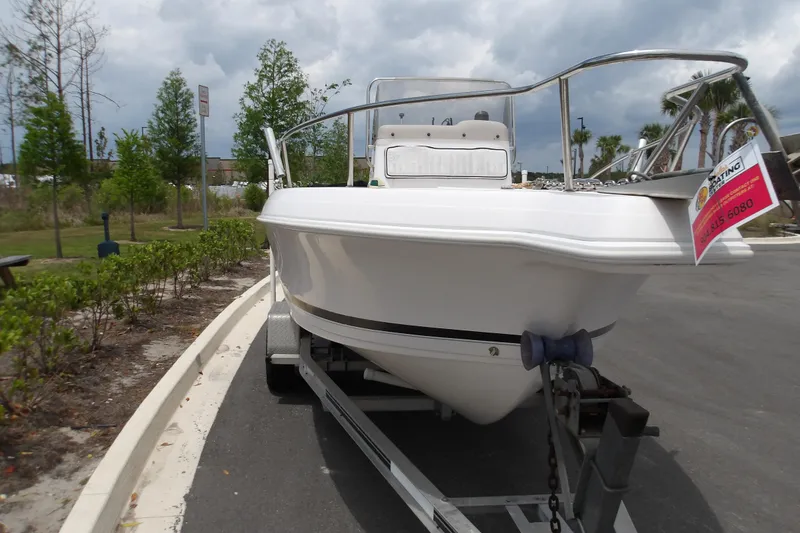 Slide: The Image of 2000 Pro-Line 19 Sport boat on trailer, parked outdoors under cloudy sky. - 3