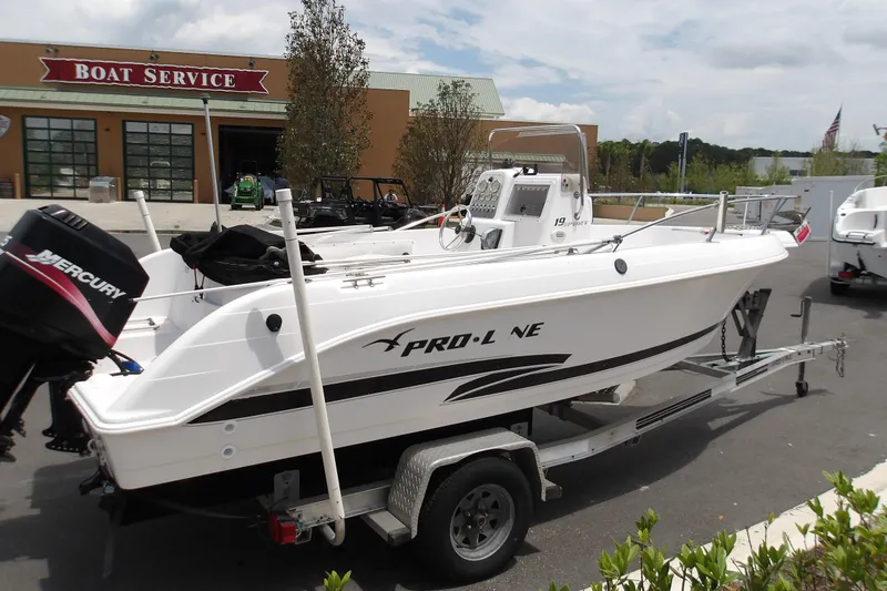 Slide: The Image of 2000 Pro-Line 19 Sport boat on trailer outside a boat service center. - 4