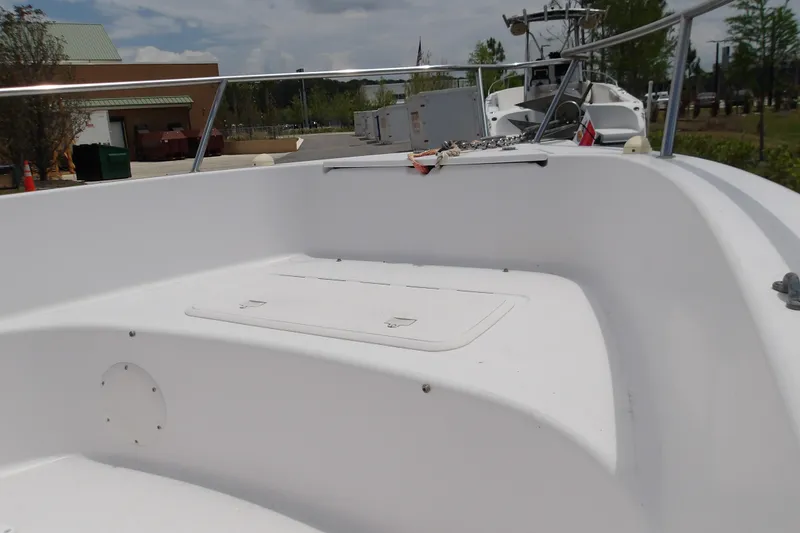 Slide: The Image of 2000 Pro-Line 19 Sport boat interior with white seating and storage compartment. - 6