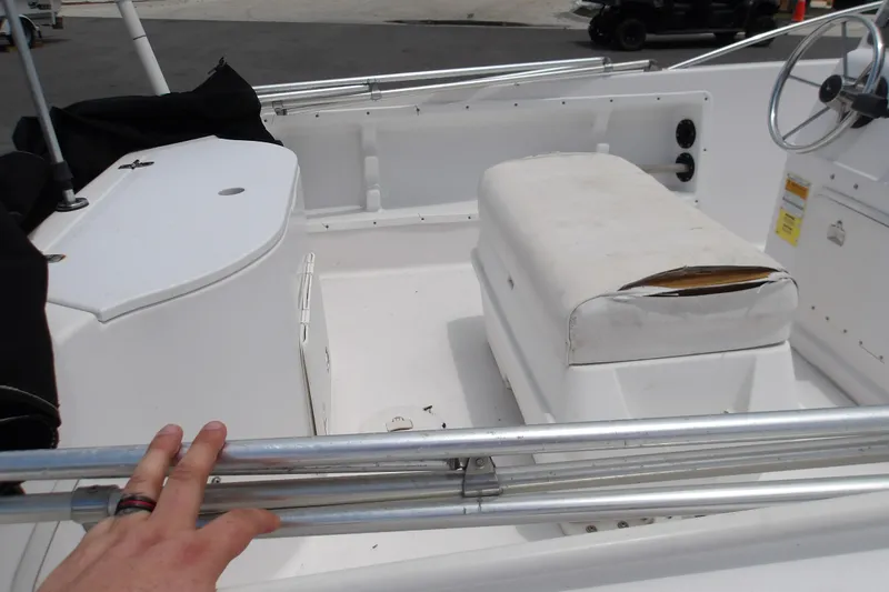 Slide: The Image of 2000 Pro-Line 19 Sport boat interior with worn seating and steering wheel. - 9