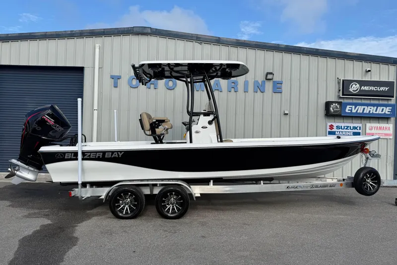 The Image of 2026 Blazer PureBay 2400 boat on trailer at marine dealership. - 1