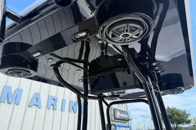 Slide: The Image of 2026 Blazer PureBay 2400 T-top with speakers and lights, marine dealership background. - 11