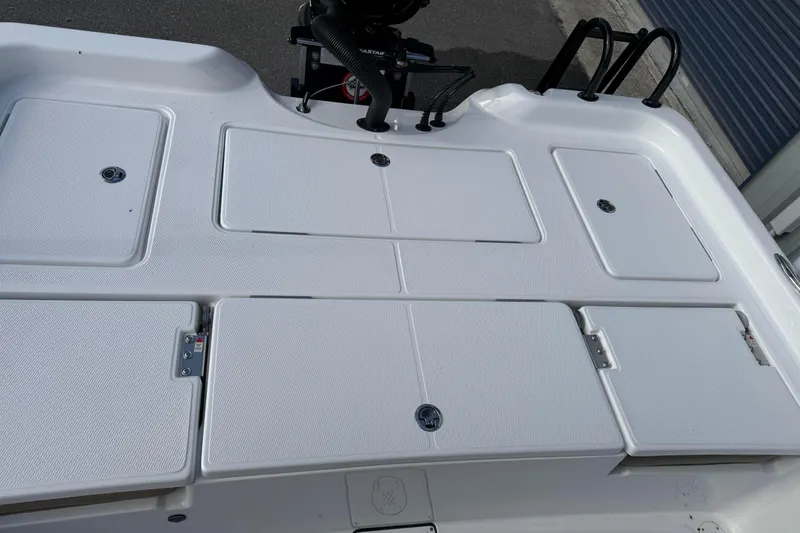 Slide: The Image of 2026 Blazer PureBay 2400 boat deck with storage compartments and motor mount. - 12