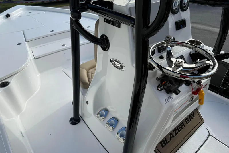 Slide: The Image of 2026 Blazer PureBay 2400 boat interior with steering wheel and control panel. - 14