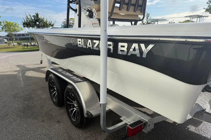 Slide: The Image of 2026 Blazer PureBay 2400 boat on trailer, showcasing sleek design and branding. - 7