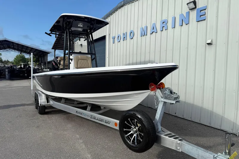 Slide: The Image of 2026 Blazer PureBay 2400 boat on trailer at Toho Marine dealership. - 9