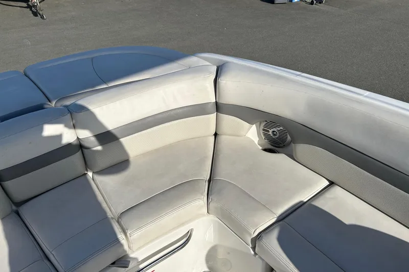 Slide: The Image of 2007 Chaparral 246 SSi boat interior with white cushioned seating and speaker. - 10