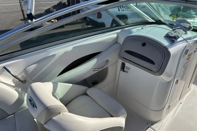 Slide: The Image of Interior of a 2007 Chaparral 246 SSi boat, featuring white seating and dashboard. - 11