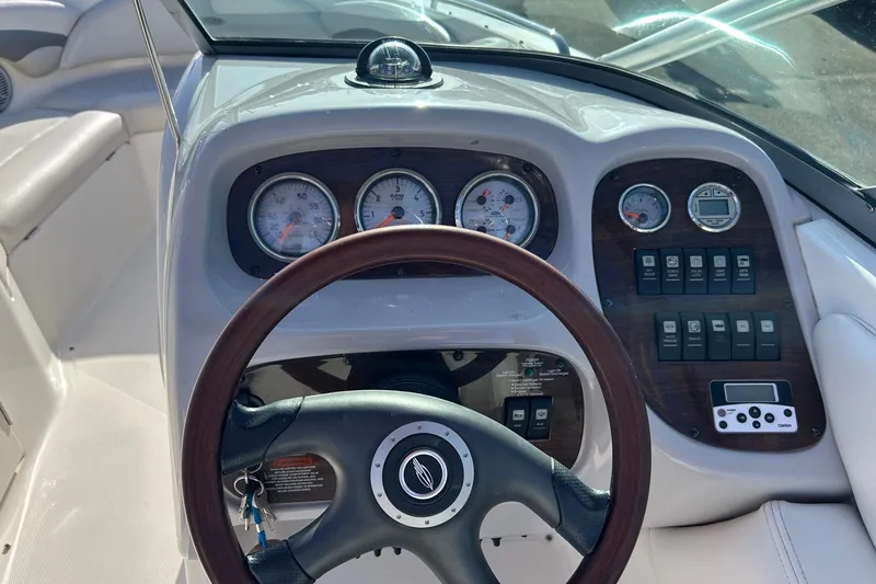 Slide: The Image of 2007 Chaparral 246 SSi boat dashboard with gauges and steering wheel. - 13