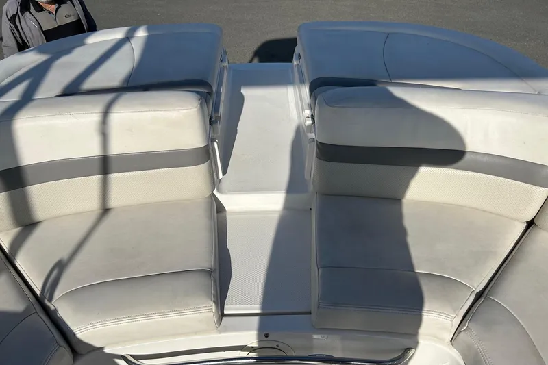 Slide: The Image of 2007 Chaparral 246 SSi boat interior with white cushioned seating. - 16