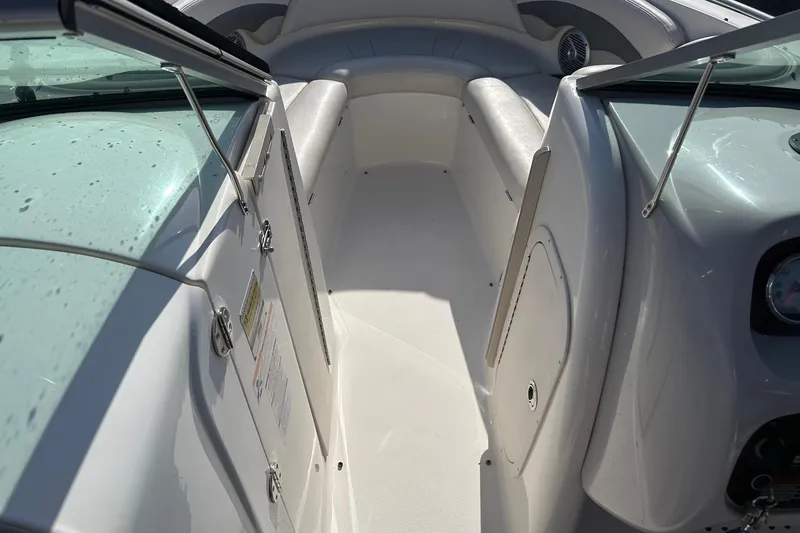 Slide: The Image of 2007 Chaparral 246 SSi boat interior with white seating and open windshield. - 17