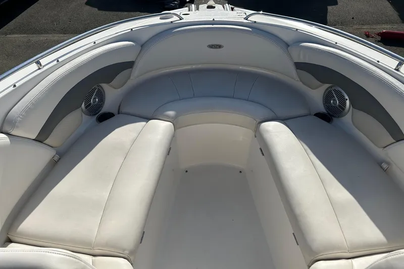 Slide: The Image of 2007 Chaparral 246 SSi boat interior with white cushioned seating and built-in speakers. - 18