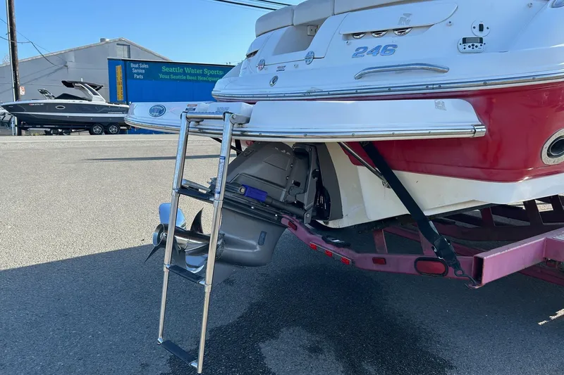 Slide: The Image of 2007 Chaparral 246 SSi boat rear view with ladder and propeller, parked outdoors. - 3