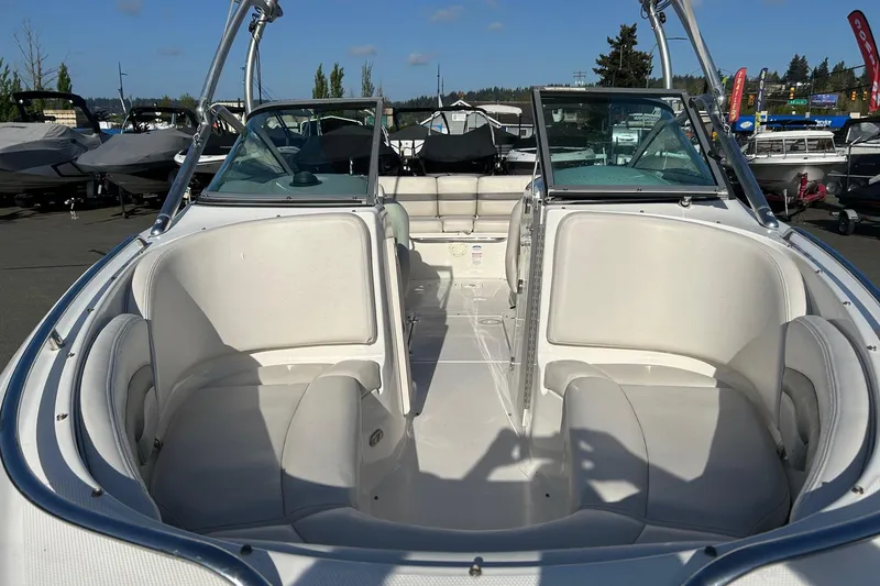 Slide: The Image of 2007 Chaparral 246 SSi boat interior with white seating and open deck layout. - 5