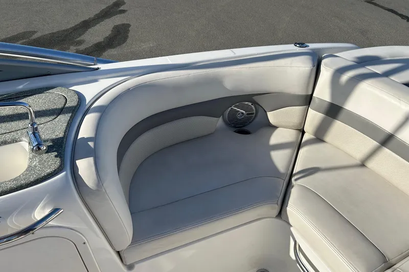 Slide: The Image of 2007 Chaparral 246 SSi boat interior with white seating and built-in speaker. - 9