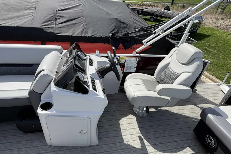 Slide: The Image of 2022 Godfrey Sweetwater 2286 C boat interior with captain's chair and control panel. - 10