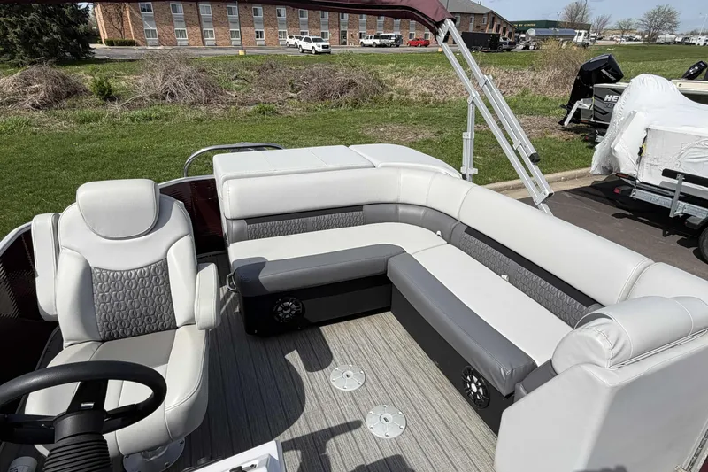 Slide: The Image of 2022 Godfrey Sweetwater 2286 C pontoon boat interior with plush seating and steering wheel. - 11