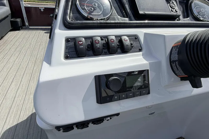Slide: The Image of Control panel of 2022 Godfrey Sweetwater 2286 C boat with switches and gauges. - 14