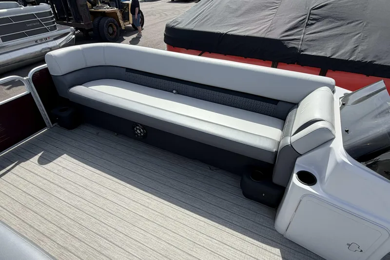 Slide: The Image of 2022 Godfrey Sweetwater 2286 C boat interior with cushioned seating and cup holders. - 7