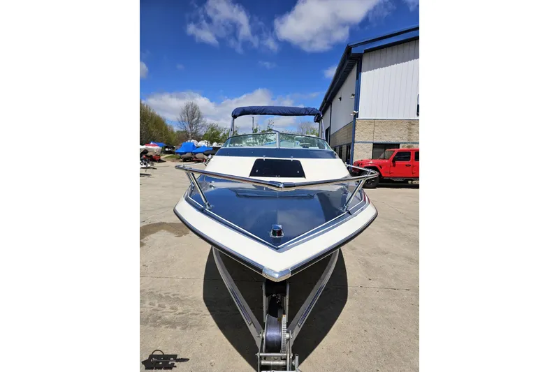 Slide: The Image of 1988 Glastron/Carlson CVX-23 boat on trailer, parked outdoors under blue sky. - 10