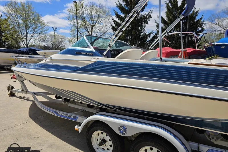 Slide: The Image of 1988 Glastron/Carlson CVX-23 boat on trailer, parked outdoors under blue sky. - 20