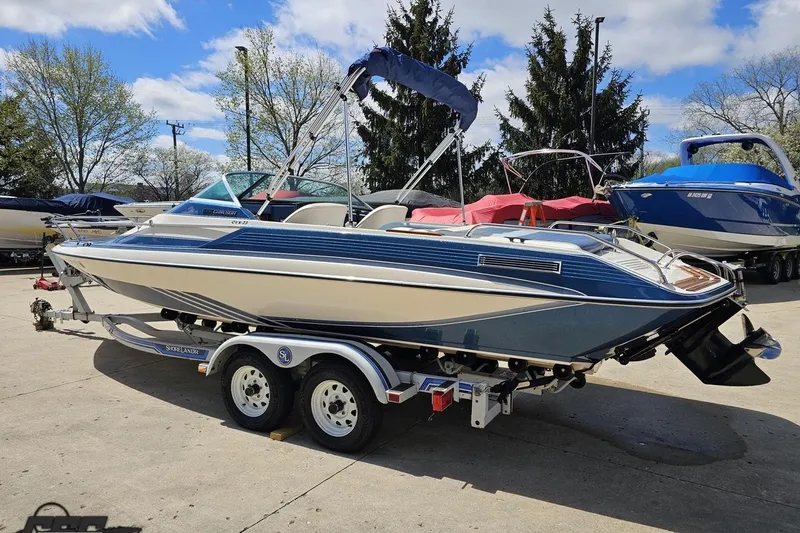 Slide: The Image of 1988 Glastron/Carlson CVX-23 boat on trailer, parked outdoors under blue sky. - 22
