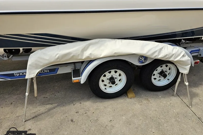 Slide: The Image of 1988 Glastron/Carlson CVX-23 boat trailer with cover, featuring dual wheels. - 31