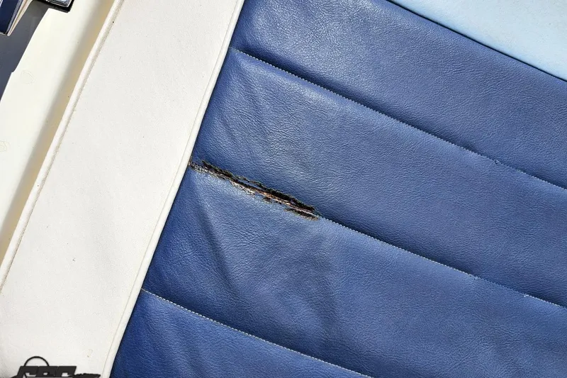 Slide: The Image of Torn blue upholstery on 1988 Glastron/Carlson CVX-23 boat seat. - 38